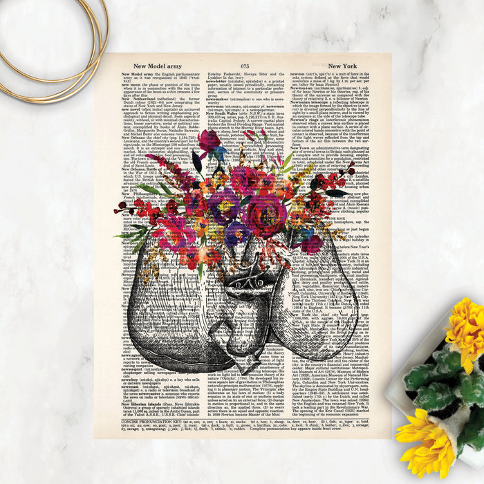 liver etching with watercolor flowers in pinks, purples, yellow and golden tones with greenery printed on a dictionary page