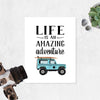 quote Life is an amazing adventure with a blue SUV with a surf board on the roof rack at the bottom printed on matte white paper