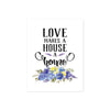 love makes a house a home printed above a spray of blue flowers with greenery on matte white paper