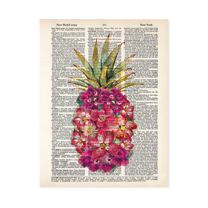 shades of pink watercolor tropical flowers form the shape of a pineapple with traditional pineapple greenery at the top printed on a dictionary page
