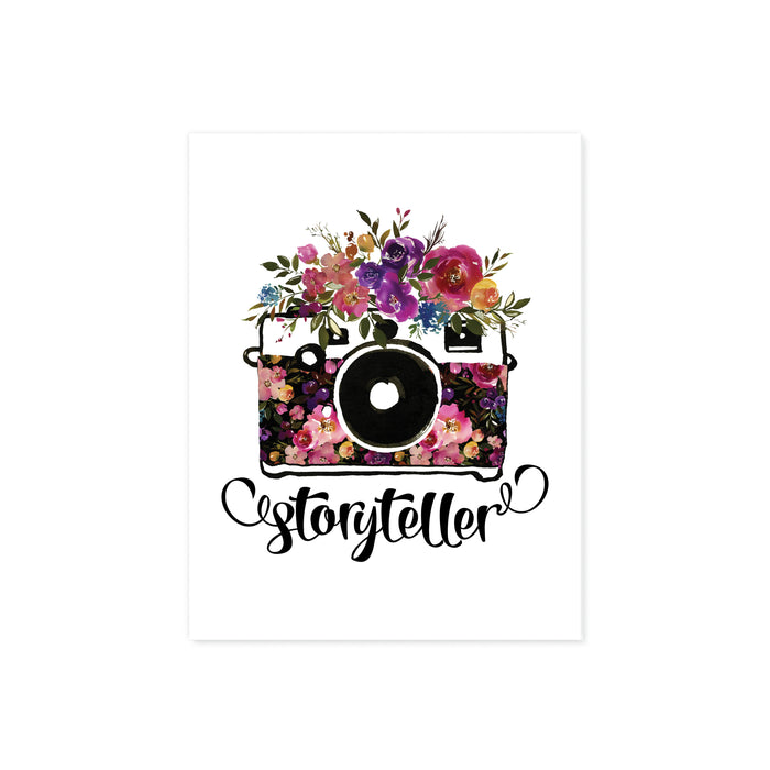 storyteller with watercolor camera and flowers in the body of the camera and on top in shades of pinks, purples, yellow, and blue with greenery printed on matte white paper