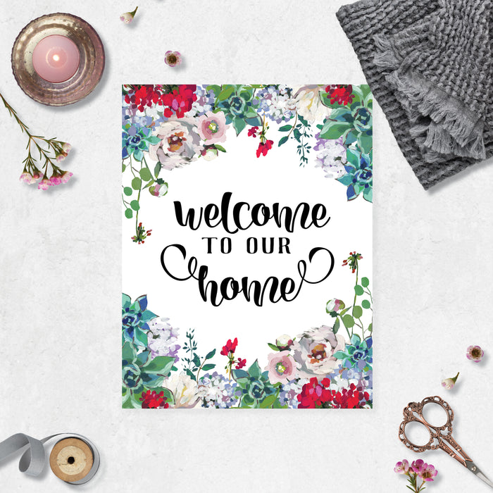 welcome to our home with watercolor flowers top and bottom in pale pink, bright berry color with greenery top and bottom on matte white paper