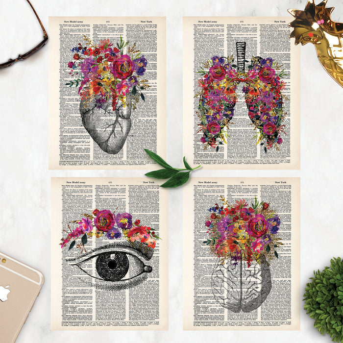 Four prints for the price of three includes vintage etching of heart, lungs, eye, and brain all adorned with watercolor flowers in shades of pinks, purples, yellows, and golden tones