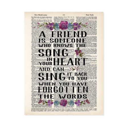 a friend is someone who knows the song in your heart and can sing it back to you when you have forgotten the words, this quote is printed on a salvaged dictionary page and has watercolor flowers in purples and blues