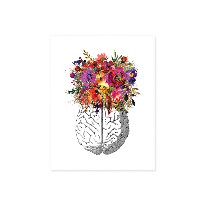 vintage etching of the top view of a brain topped with watercolor flowers in shades of pink, purple, golden and yellow toneson matte white paper