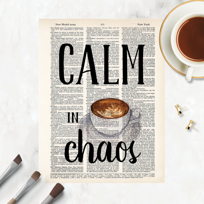 calm in chaos with a water color coffee cup with cream design on a saucer printed on a salvaged dictionary page