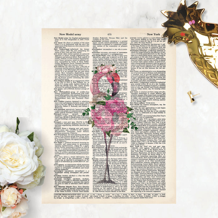 watercolor flamingo with flowers making up her body and a flowers in her head, all in pink tones with greenery printed on salvaged dictionary page