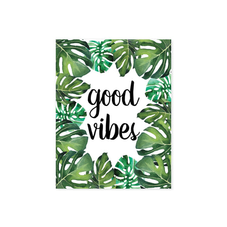 good vibes in black ink surrounded by tropical monstera leaves on matte white paper