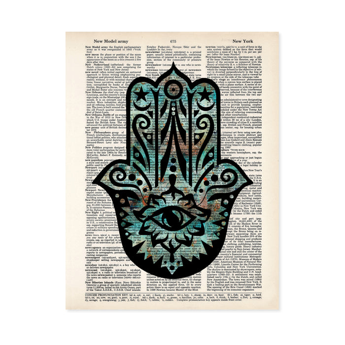 hamsa evil eye hand with blues and orange and black printed on a salvaged dictionary page