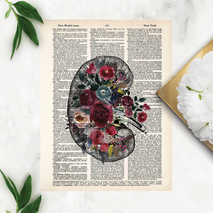 vintage kidney etching topped with watercolor flowers in shades of berry reds and blues printed on a dictionary page
