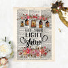 let your light shine is printed in black ink, at the top of the page there is a spray of pink and salmon colored flowers with five lanterns glowing amber with light, there are matching flowers and greenery at the bottom of the dictionary page