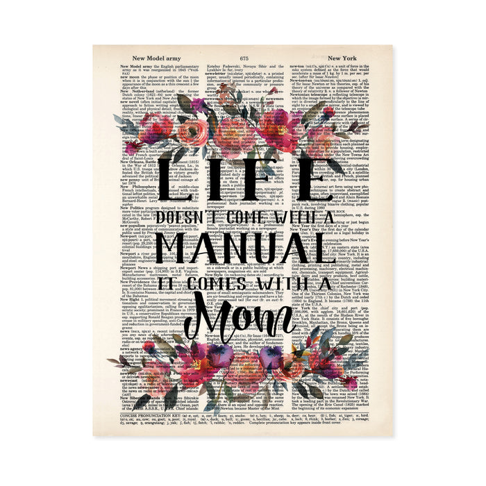 Watercolor flowers in pinks and peach tones top and bottom with the words Life doesn't come with a manual it comes with a mom in between printed on a salvaged dictionary page