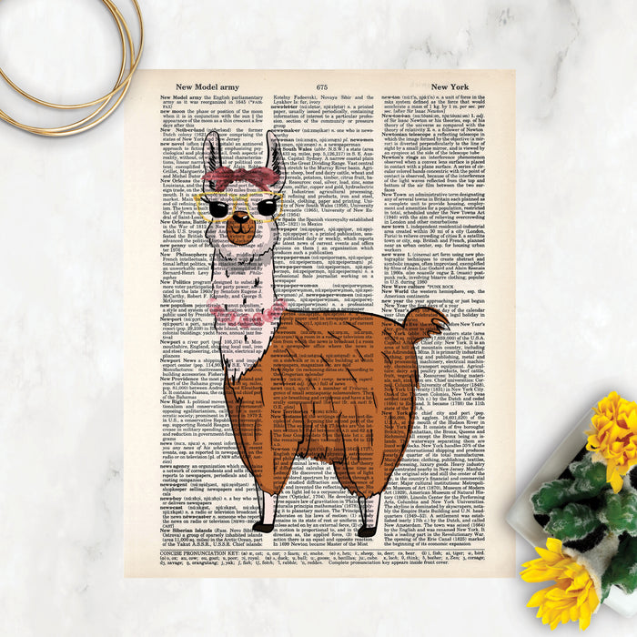 watercolor llama with a bow in her hair wearing yellow framed glasses and pink pearls around her neck printed on salvaged dictionary paper