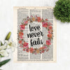 love never fails surrounded by a wreath of pink and coral watercolor flowers with greenery printed on dictionary page