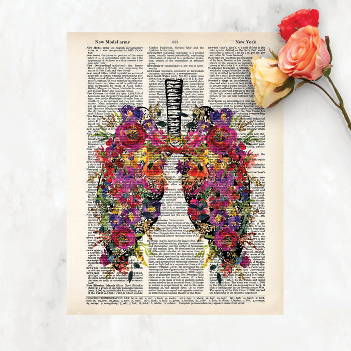 vintage lung etching topped with watercolor flowers in pinks, purples, yellow, with greenery printed on a dictionary page