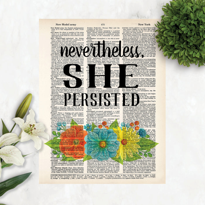 nevertheless she persisted with vibrant orange glue and yellow flowers and greenery printed on a dictionary page