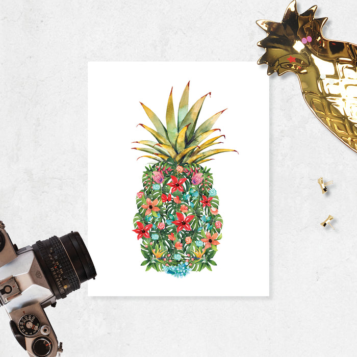 watercolor monstera leaves along with pink, red, peach, and blue flowers along with red and blue shells and coral form a pineapple shape with a traditional pineapple top printed on matte white paper