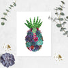 watercolor suculents in greens and purples along with pink and red flowers in the shape of a pineapple with an aloe vera at the top to be the pineapple leaves printed on matte white paper