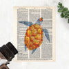 watercolor sea turtle with deep blue fins and head and a golden shell printed on dictionary paper