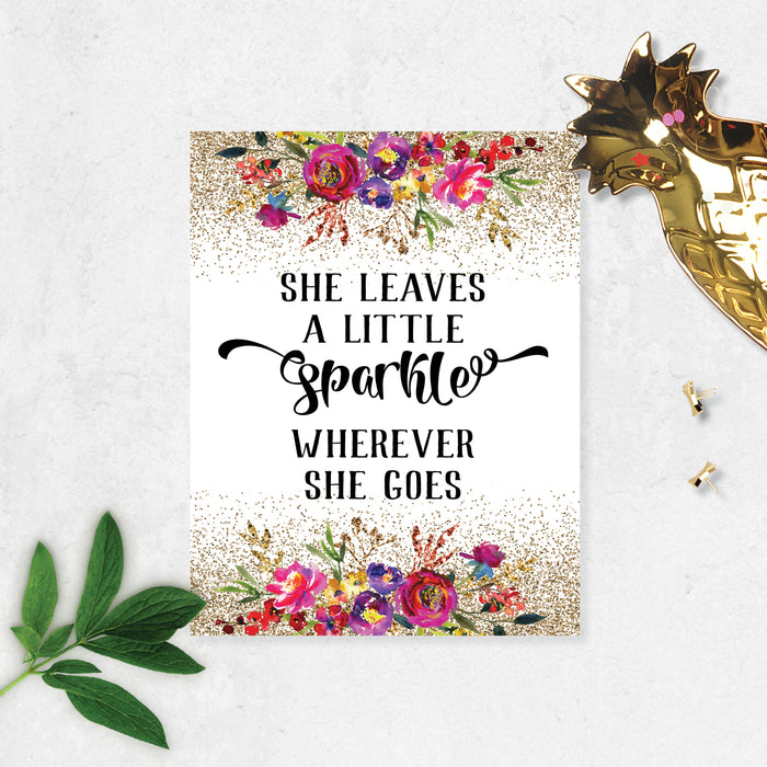 she leaves a little sparkle wherever she goes with top and bottom golden look sprinkles with flowers in pink, purple, yellow with greenery watercolors printed on matte white paper
