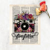 storyteller with watercolor camera and flowers in the body of the camera and on top in shades of pinks, purples, yellow, and blue with greenery printed on a dictionary page 